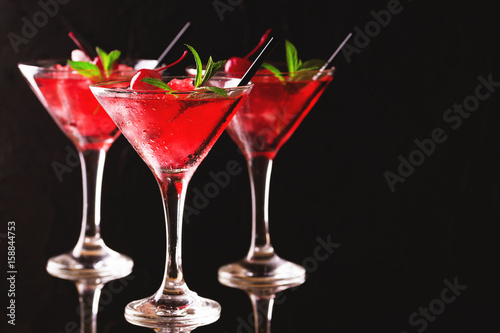 Strawberry daiquiri cocktail with lime, strawberry, cherry and mint