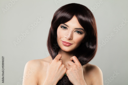 Perfect Model Young Woman with Healthy Hair. Nice Girl on Gray Banner Background