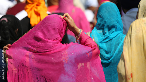 Women with the veil over their heads during a religious event on photo