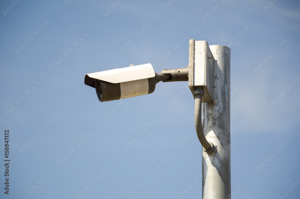 CCTV security camera front of a building in city CCTV security camera front of a building in city