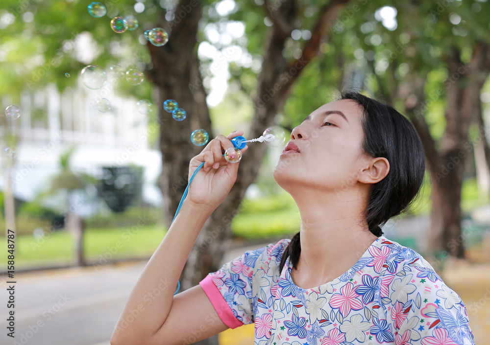 Young asian woman playing bubble in the park. Young asian woman playing bubble in the park.