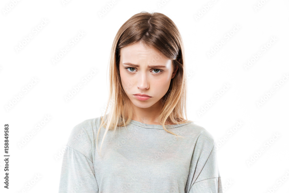 Sad young woman standing isolated over white background Sad young woman standing isolated over white background