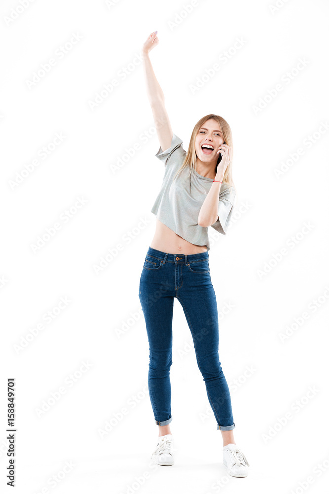 Happy woman talking on phone and raising hand Happy woman talking on phone and raising hand