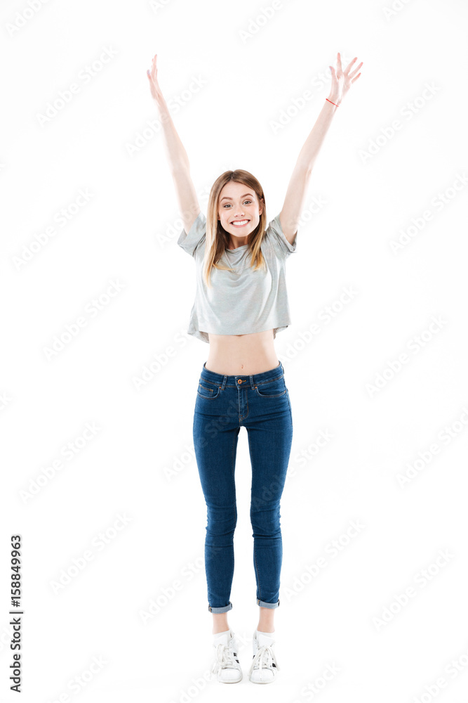 Portrait of a happy excited girl standing and celebrating success Portrait of a happy excited girl standing and celebrating success