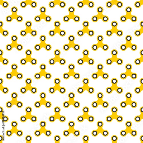Background from yellow children fidget spinners on white background. Playing backdrop of hand twisting toys with bearings in a row next to each other and alternately under him 