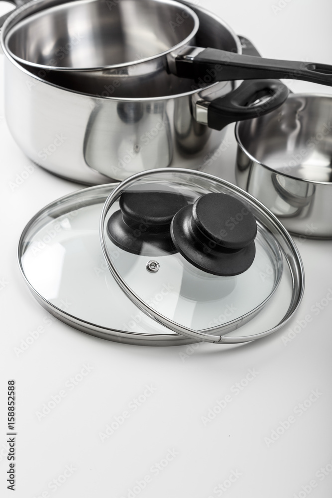 Stainless steel pots and pans isolated on white Stainless steel pots and pans isolated on white