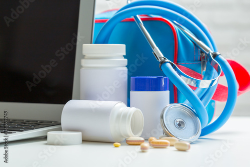  pills or capsules and stethoscope on the white table. Concept healthcare.