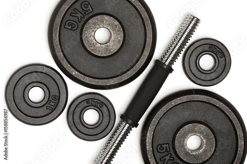 Top view of heavy weight plates with iron bar isolated on white