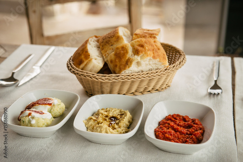 meze small dishes on the table: hummus, Antep Ezmesi photo