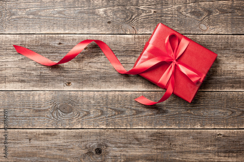 Red gift box on wooden background