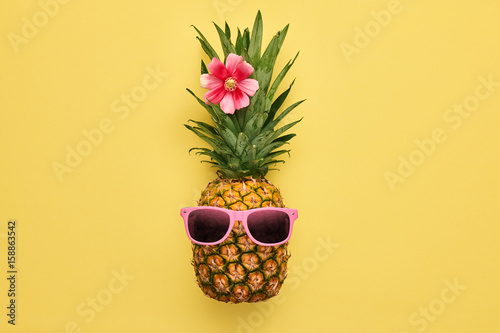 Fashion Hipster Pineapple Fruit. Bright Summer Color, Accessories. Tropical pineapple with Sunglasses. Creative Art concept. Minimal style. Summer party Yellow background
