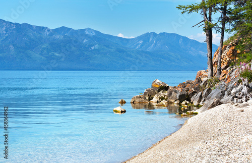 Lake Baikal in the summer. Pebble beach on the shore of the Chivyrkuy Bay