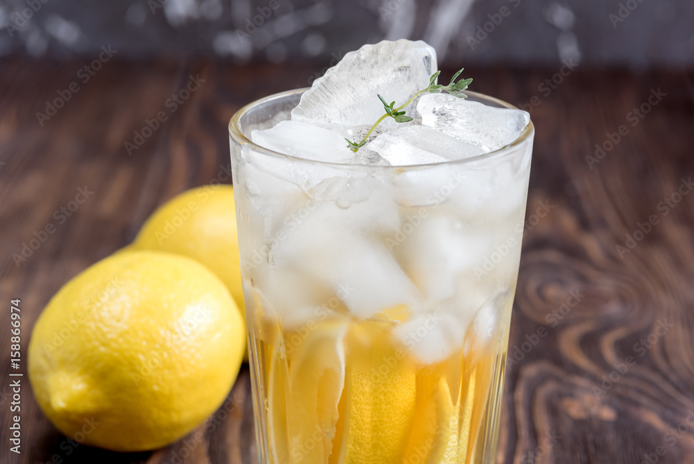 Glass of ice tea with lemon on wooden table Vertical photo Close up Glass of ice tea with lemon on wooden table Vertical photo Close up