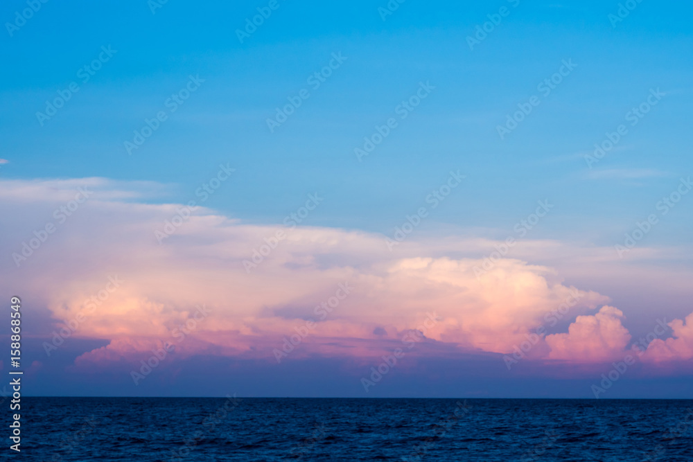 Pink clouds and sunset sky over sea