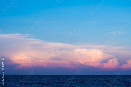 Pink clouds and sunset sky over sea