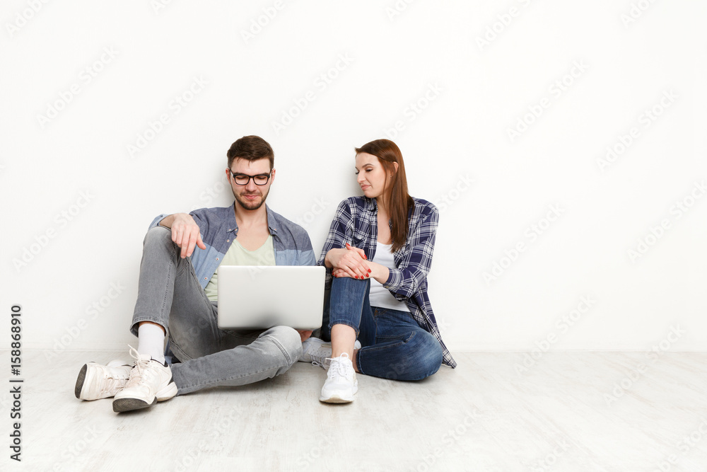 Couple discuss design project for home interior Couple discuss design project for home interior