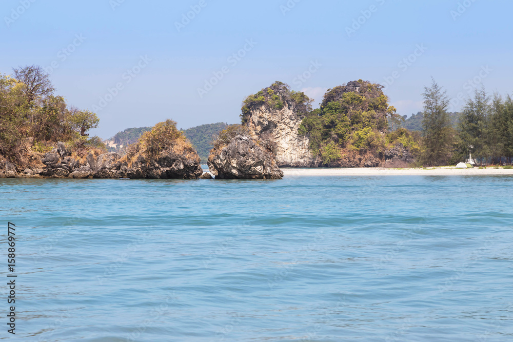 view of the tropical beach on small limestone island in andaman sea at krabi thailand.
