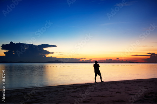 Traveler take the photography stunning sunset over the beach .Rawa island   Malaysia .