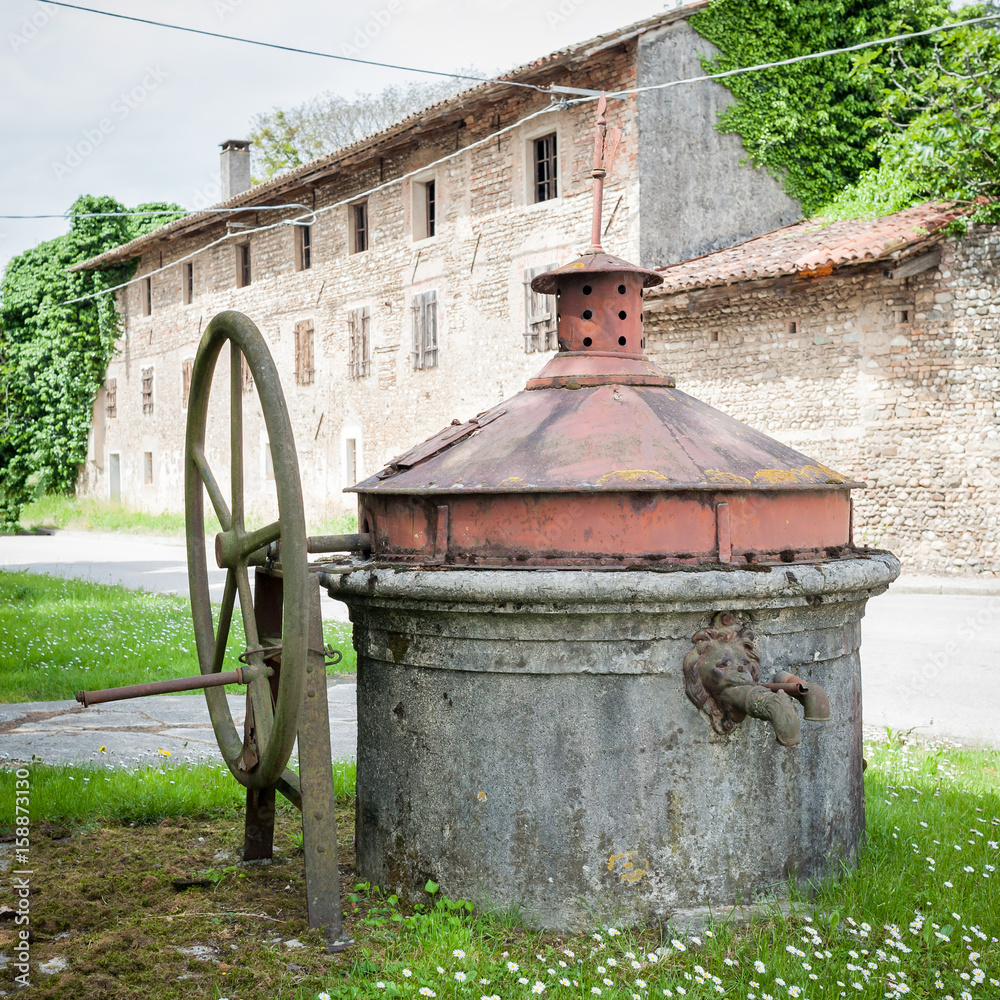 Old well covered with hand pump.