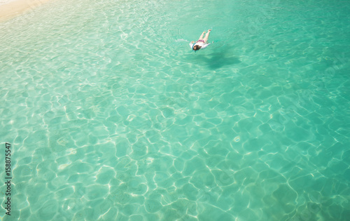 Woman snorkling and relaxing crystal clear and turquoise sea water of the tropical sea . © jamesteohart