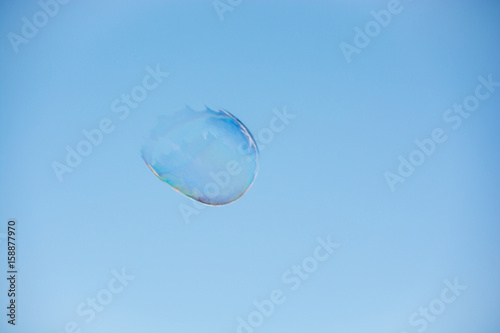 Floating soap bubble bursting