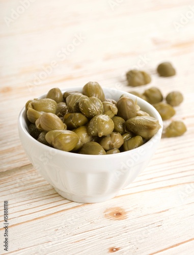 capers on wooden background