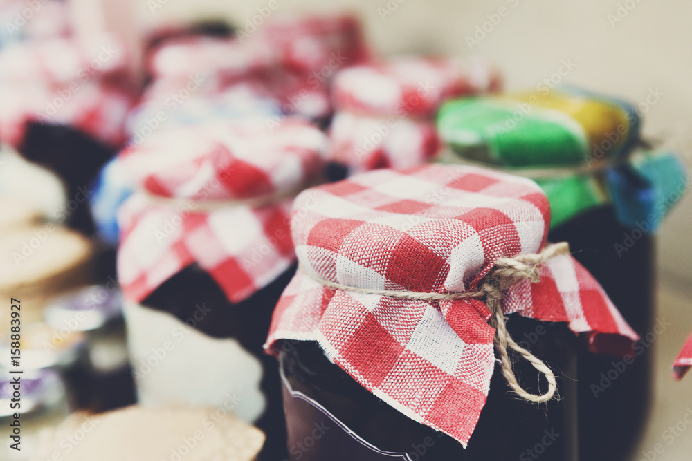 Homemade jams in glass jars for sale on country fair Homemade jams in glass jars for sale on country fair
