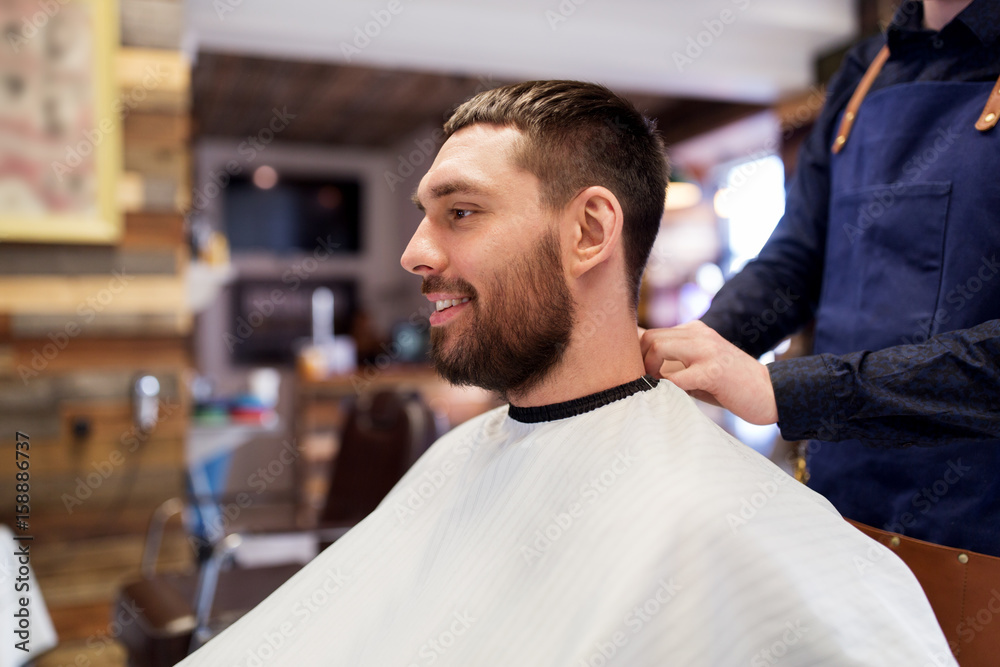 hairdresser and man with beard at barbershop hairdresser and man with beard at barbershop