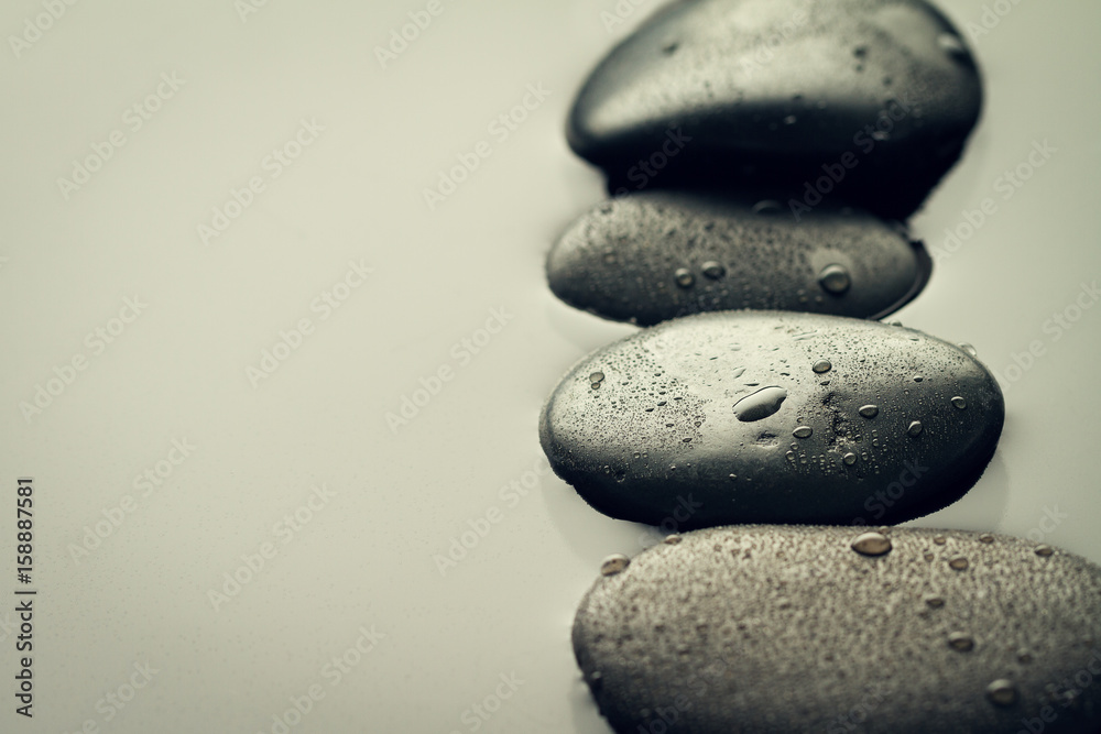Beautiful picture of Spa Hot Stones, View from Above. Dark Background. Top. Spa Concept. Side Composition. Beautiful picture of Spa Hot Stones, View from Above. Dark Background. Top. Spa Concept. Side Composition.
