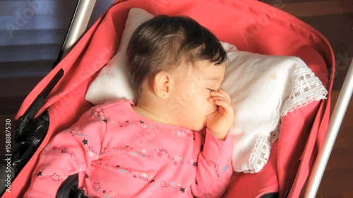 Baby sleeps in stroller, close up photo