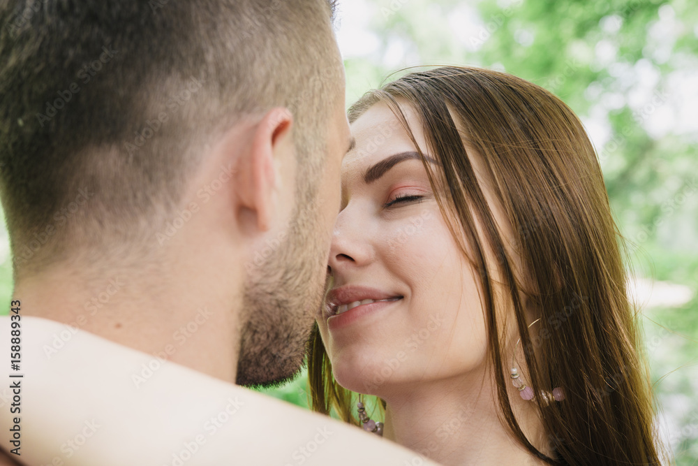 Young couple hugging and smiling at each other in the park Young couple hugging and smiling at each other in the park