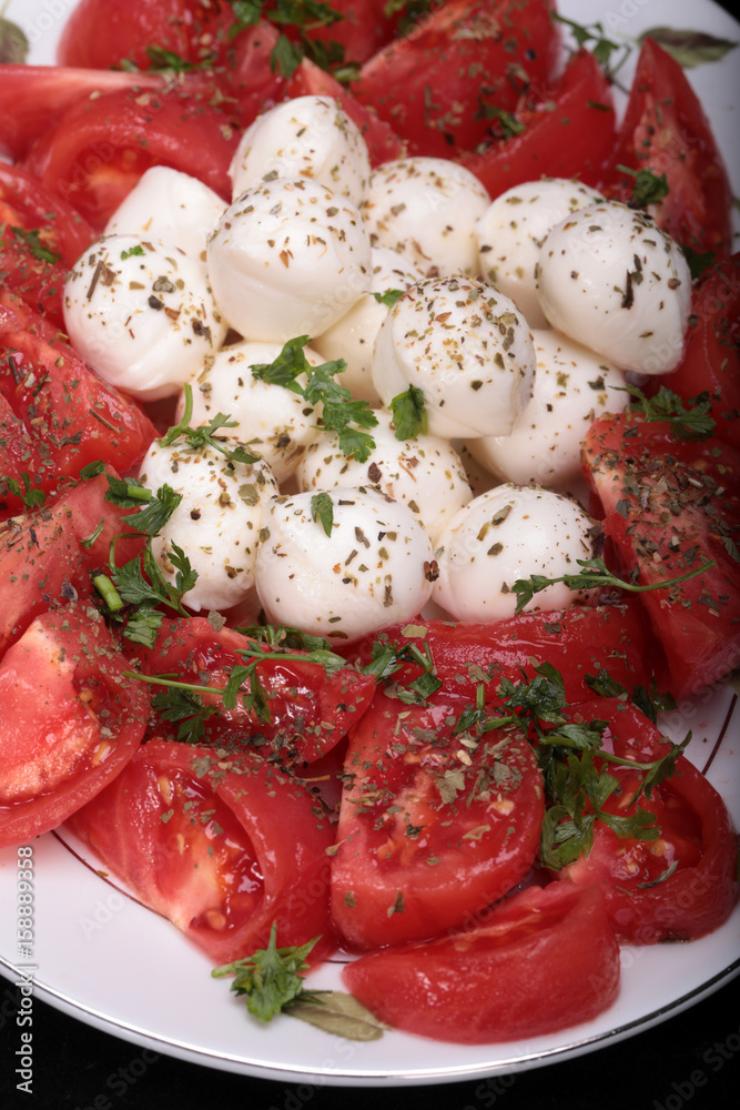 Caprese salad with tomatoes, mozzarella and herbs Caprese salad with tomatoes, mozzarella and herbs