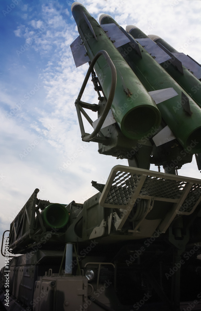 Rocket launcher on military mobile complex against blue sky Rocket launcher on military mobile complex against blue sky