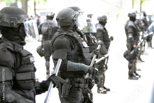 Police officers wearing riot gear.