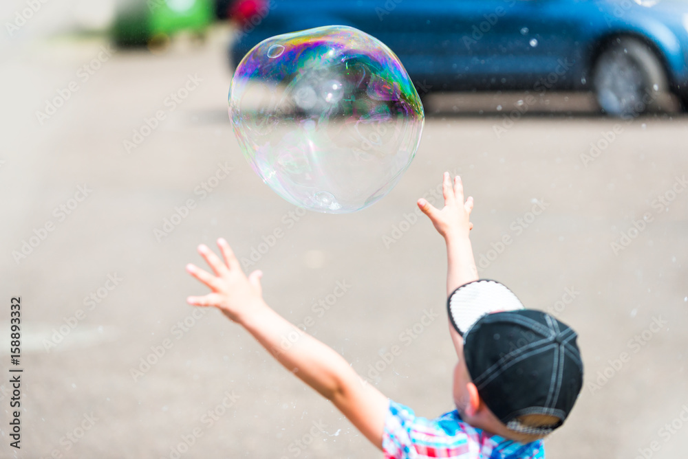 Kid Catching Bubble. Family Spending Free Time In The Park. Kid Catching Bubble. Family Spending Free Time In The Park.