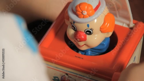 Close up, little kid plays with Jack-In-The-Box