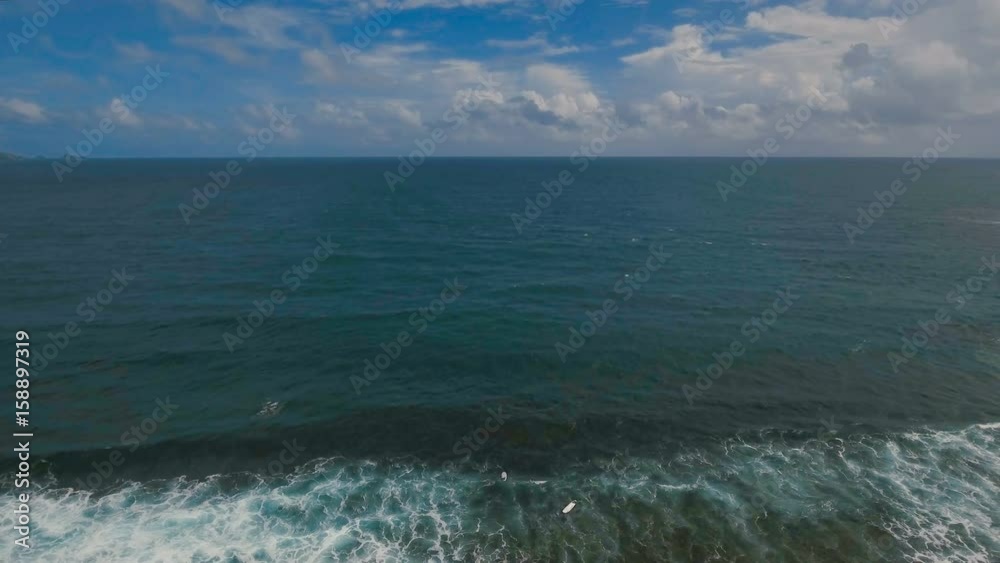 Aerial view from drone of a swimming group with surfers in open sea with beautiful swell waves. Education surfers in the ocean with big waves. Active sport leisure in Pacific Ocean.Philippines Aerial view from drone of a swimming group with surfers in open sea with beautiful swell waves. Education surfers in the ocean with big waves. Active sport leisure in Pacific Ocean.Philippines