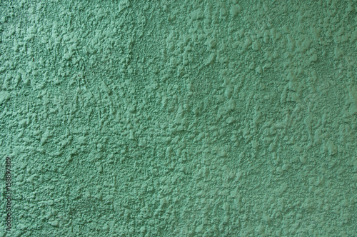 Plaster, putty, relief, on a colored wall.