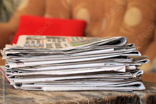 Newspapers on wooden table