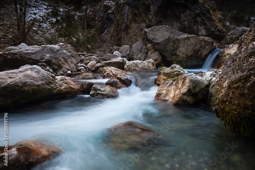 The mountain river with a waterfall.