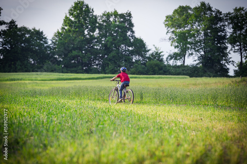 boy ride on bike on rural landscape © Sergiy Bykhunenko