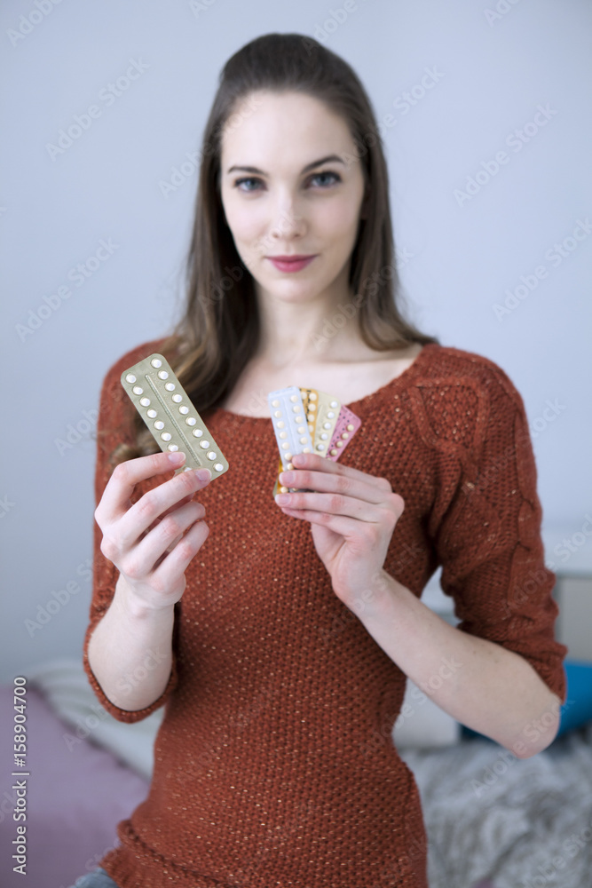 Woman holding contraceptive pills Woman holding contraceptive pills