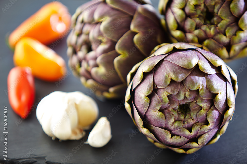 Fototapeta premium three artichokes with garlic bulb and chilis