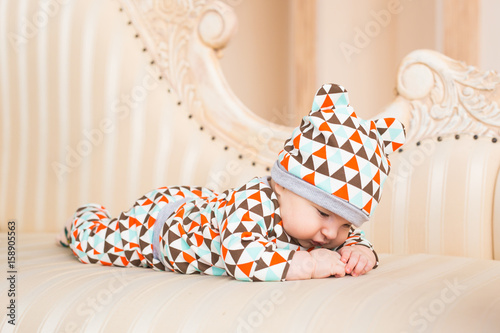 Portrait of a crawling baby on the bed in her room.
