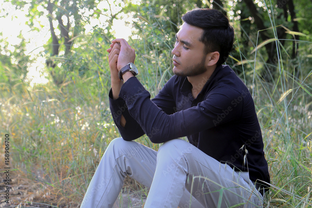 Handsome man outdoors sitting on stone stairs Handsome man outdoors sitting on stone stairs