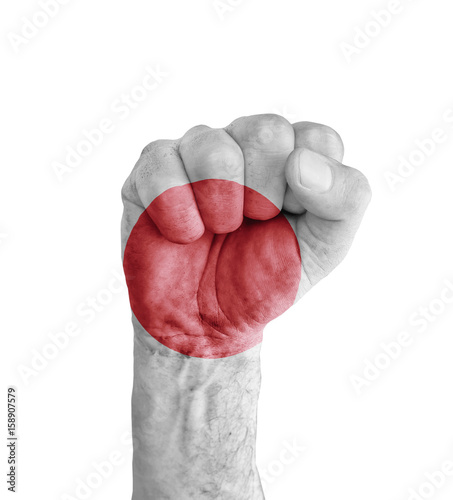 Flag of Japan painted on human fist like victory symbol photo