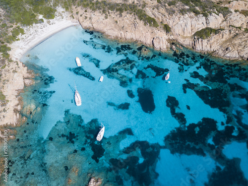 Aerial view of boats in front of Mortorio island in Sardinia. Amazing beach with a turquoise and transparent sea. Emerald Coast  Sardinia  Italy...