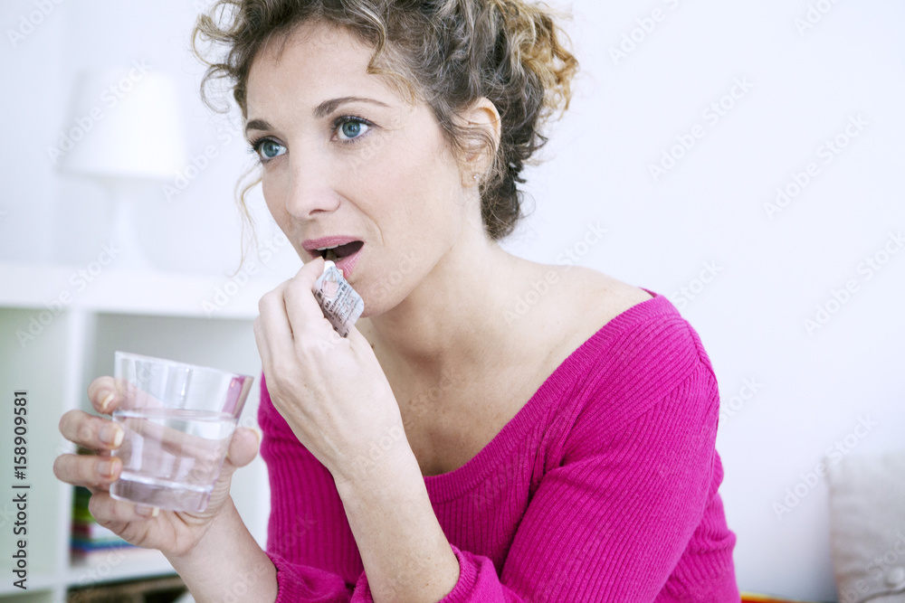 Woman taking medication Woman taking medication