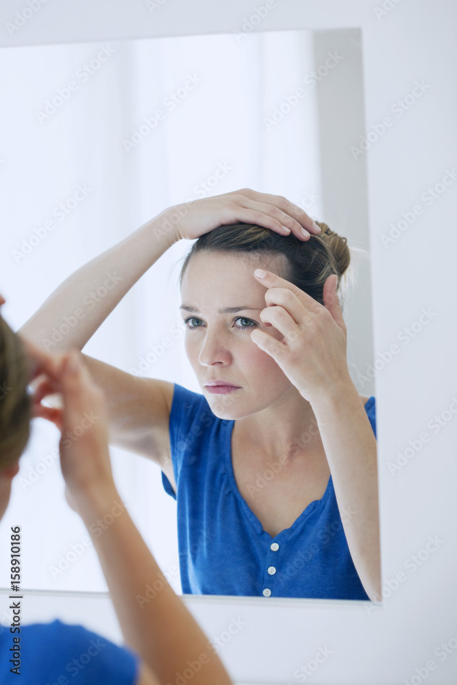 Woman looking in a mirror