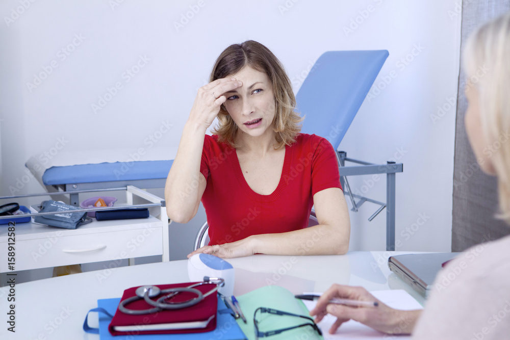 Female patient consulting for headache Female patient consulting for headache